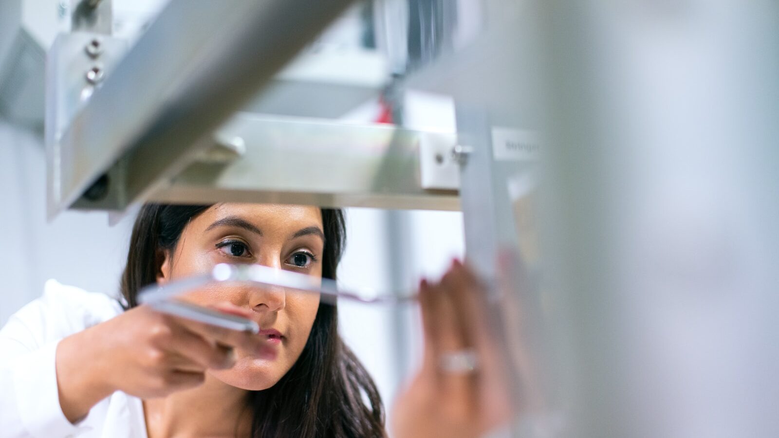 woman in white tank top holding mirror for artificial intelligence post