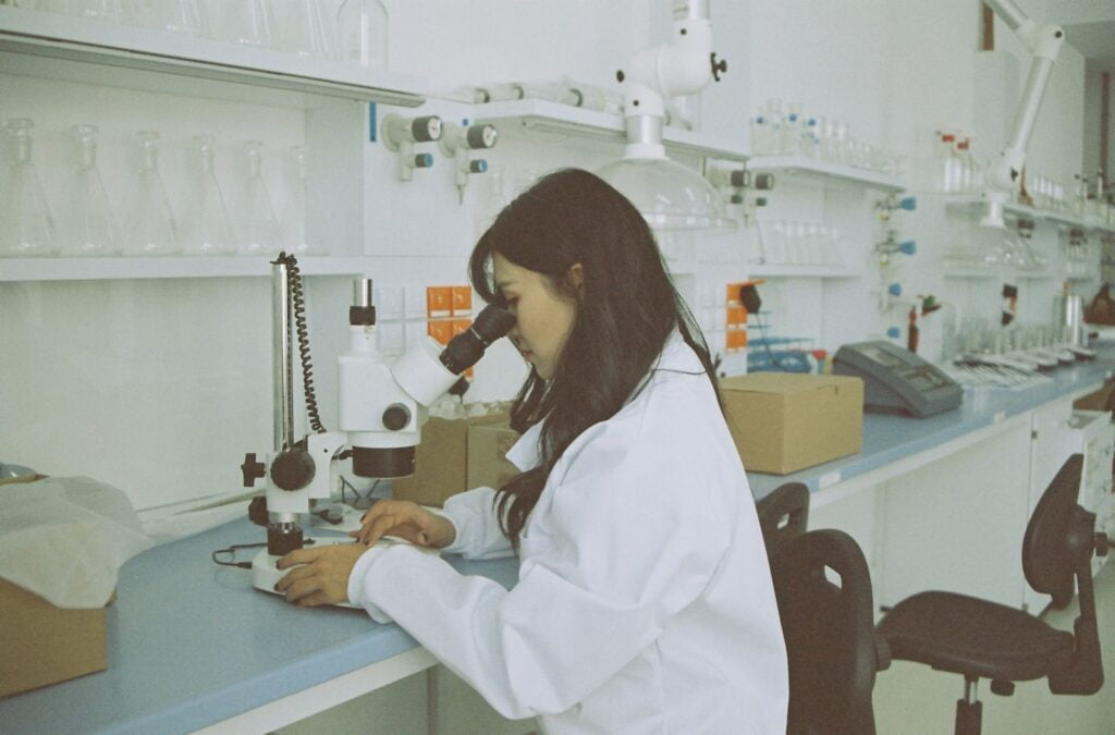 woman in white long sleeve shirt using white and black sewing machine for clinical trials post